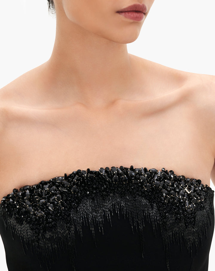 A black column gown with crystal degrade embroidery