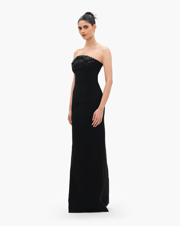 A black column gown with crystal degrade embroidery