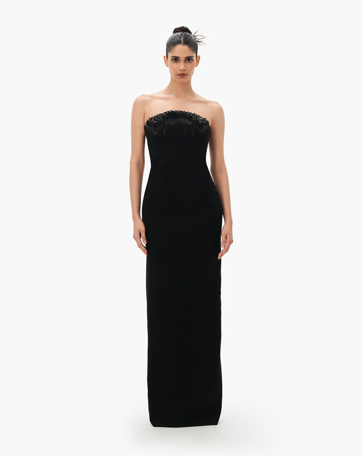 A black column gown with crystal degrade embroidery